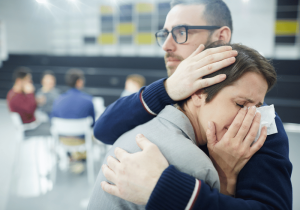 woman comforted during period of ambiguous grief seeking grief therapy and counselling for loss